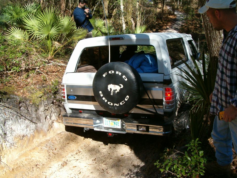 1991 Ford Bronco on a dirt trail, spare tire mounted on rear door