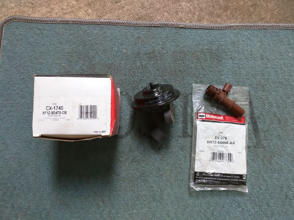 EGR valve box and Motorcraft PCV valve packaging on a mat