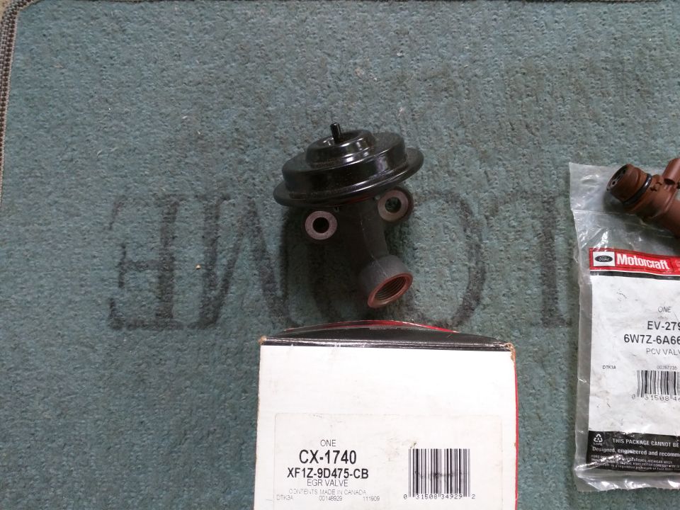 Black EGR valve and Motorcraft PCV valve with packaging and box.