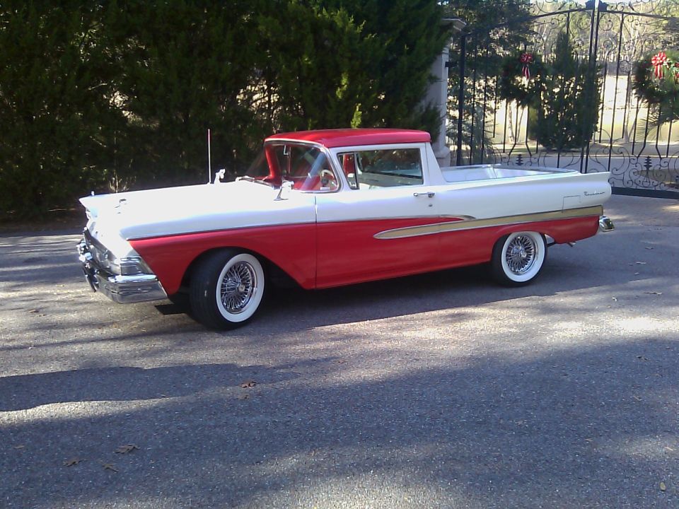 1958 Ford Ranchero, red and white, with gold stripe, wire wheels, parked outside