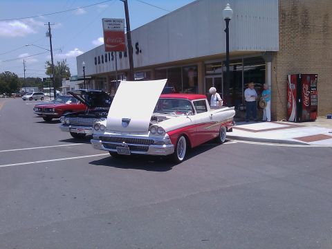 1958 Ford Ranchero - A classic 1958 Ford Ranchero is displayed with its hood up, alongside other vehicles.