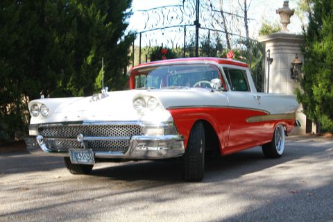 1958 Ford Ranchero - This 1958 Ford Ranchero features a distinctive two-tone red and white paint scheme and a prominent front grille.