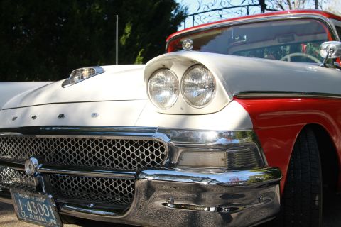 1958 Ford Ranchero - Close-up of the front end of a classic two-tone Ford, a large chrome grille and distinctive headlights.