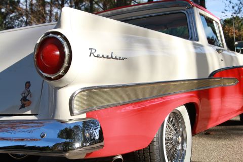 1958 Ford Ranchero - Rear quarter view of a two-tone 1958 Ford Ranchero pickup truck with a distinctive tail fin and chrome trim.
