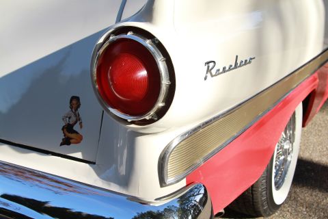 1958 Ford Ranchero - Close-up of the rear of a 1958 Ford Ranchero, a distinctive taillight, chrome trim, and a playful pin-up girl decal.