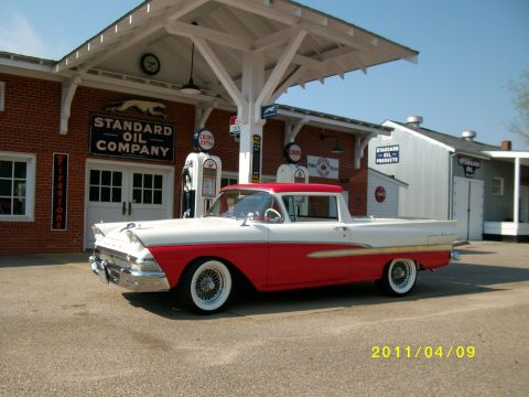 1958 Ford Ranchero - Classic two-tone pickup truck sits in front of a vintage Standard Oil gas station.