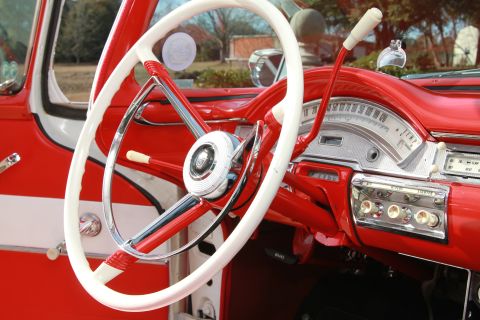 1958 Ford Ranchero - The interior of a 1958 Ford Ranchero features a two-tone steering wheel and a detailed dashboard with chrome accents.