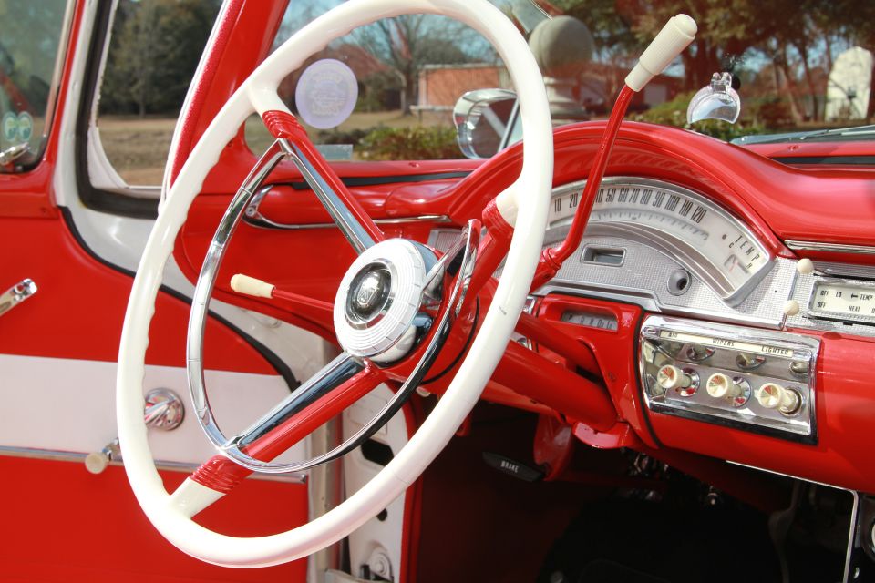 1958 Ford Ranchero interior with red dashboard and white steering wheel