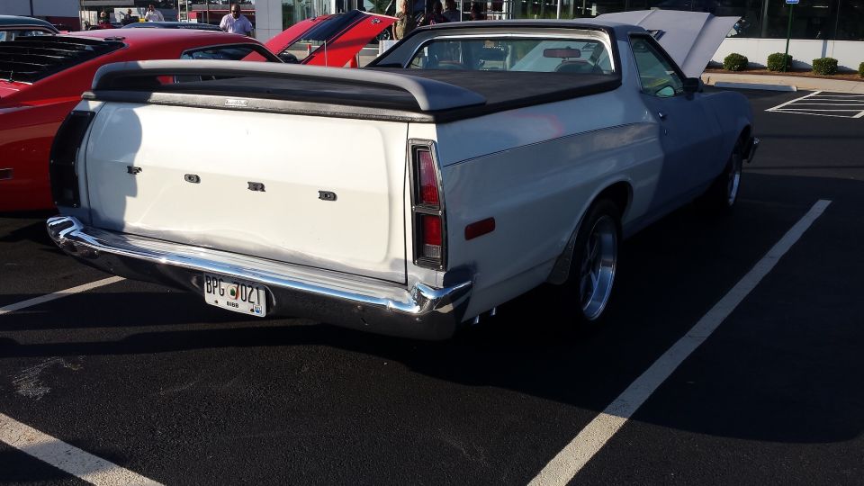 Rear view of a 1976 Ford Ranchero with a white bed and blue cab