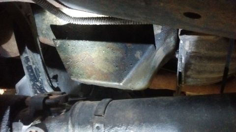 1985 Ford Bronco - Underside view of vehicle drivetrain components, including a driveshaft and suspension parts. No year-specific details are visible.