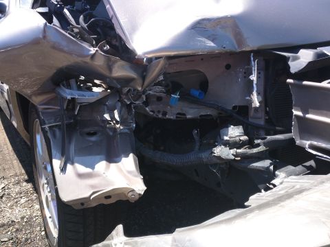 2007 Ford Crown Victoria - Significant front-end damage is visible on this vehicle, with crumpled body panels and exposed mechanical parts.