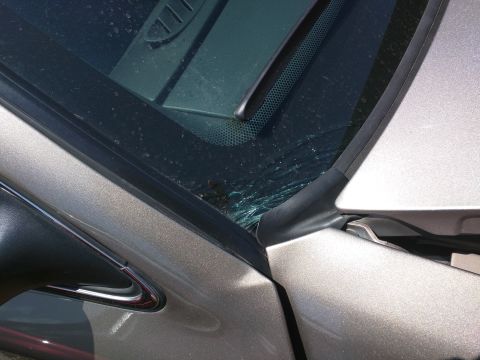2007 Ford Crown Victoria - Close-up of a damaged car windshield and adjacent bodywork.