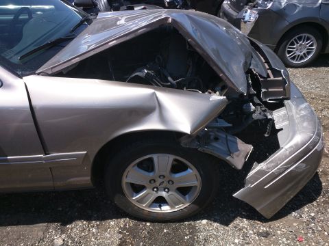 2007 Ford Crown Victoria - This heavily damaged vehicle shows significant front-end collision impact.