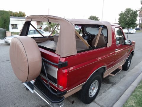 1994 Ford Bronco - Rear view of a 1994 Ford Bronco a tan soft top and external spare tire.
