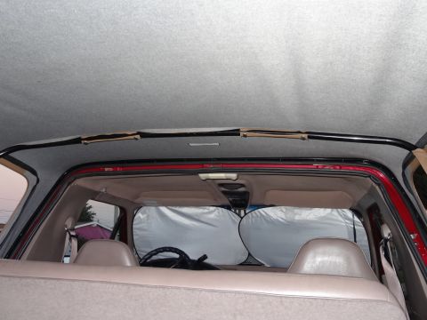 1994 Ford Bronco - The interior of the SUV shows sunshades covering the windshield and the rear seating area.