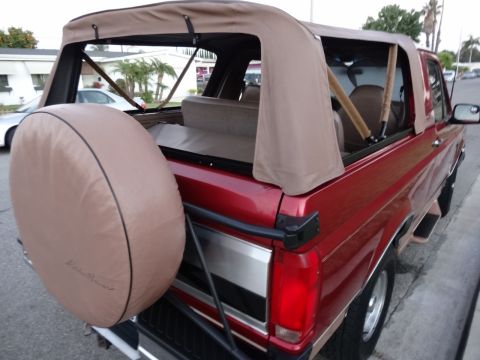 1994 Ford Bronco - This 1994 Ford Bronco features a removable tan soft top and a rear-mounted spare tire.