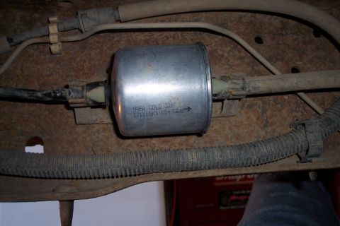 1990 Ford Bronco - Close-up of a NAPA Gold 3097 fuel filter, part number 121115K1, USA/EEUU.