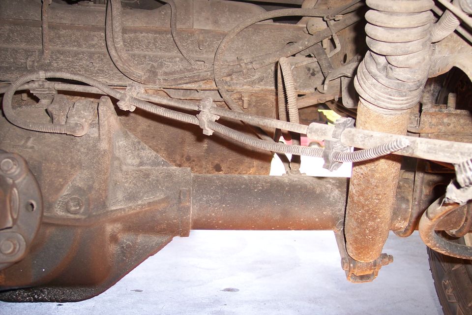 rear axle, brake lines, and shock absorber on a vehicle