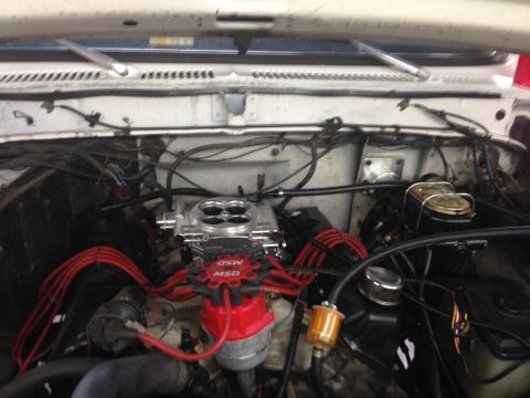1979 Ford Bronco - Close-up view of an engine bay aftermarket performance parts like a new carburetor and distributor.
