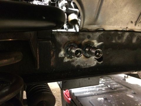 1964 Ford Fairlane - Two metal fittings with threaded ends are welded onto the underside of a vehicle's frame. The fittings appear to be part of a custom modifi…