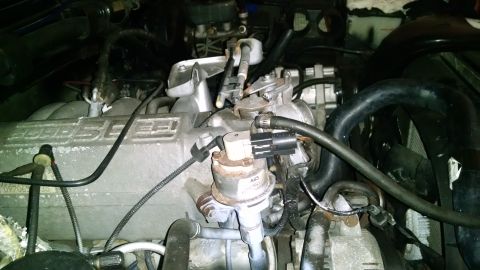 1995 Ford Bronco - This is a close-up view of the engine bay of a 1995 Ford Bronco, focusing on the intake manifold and various engine components. The "FORD 5…