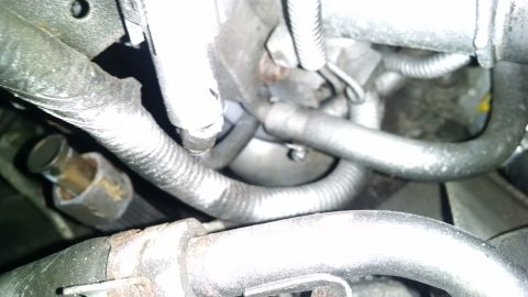 1995 Ford Bronco - A close-up view of engine components, including hoses and wiring harnesses, likely from a 1995 Ford Bronco.