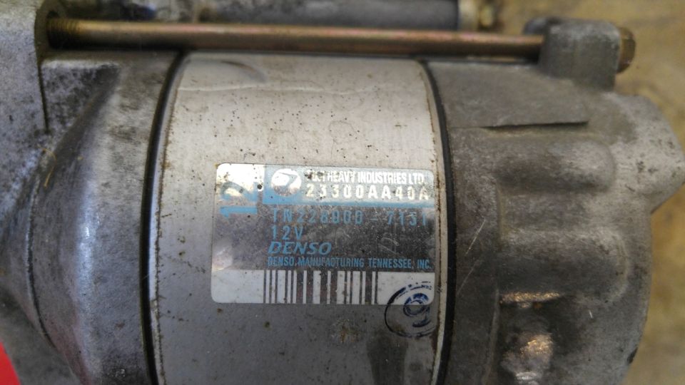 Close-up of a Denso starter motor with label showing part numbers.