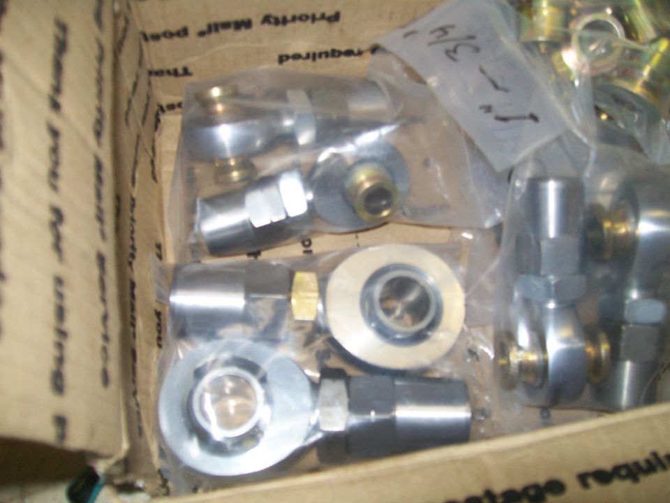 Automotive rod ends and bearings in a cardboard box.