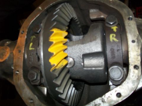 1991 Ford Bronco - A close-up view of the differential gears within a vehicle's rear axle housing. Yellow markings are visible on the gears and housing, indic…