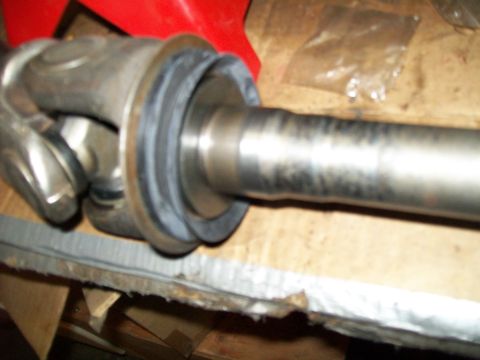 1991 Ford Bronco - A close-up view shows a driveshaft with a universal joint and a rubber seal. The driveshaft appears to be part of a 1991 Ford Bronco.