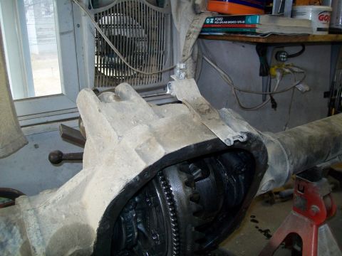 1991 Ford Bronco - A close-up view of an open differential housing and axle assembly, likely from a 1991 Ford Bronco, resting on jack stands. The internal gea…