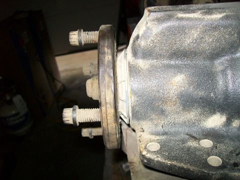 1991 Ford Bronco - A close-up view shows a differential housing secured by bolts to a flange. The housing is heavily coated in dust and grime.