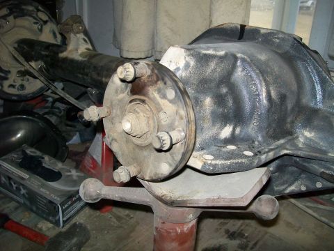 1991 Ford Bronco - A close-up view of a vehicle's rear differential assembly, possibly from a 1991 Ford Bronco, is mounted on a stand in a workshop setting. T…