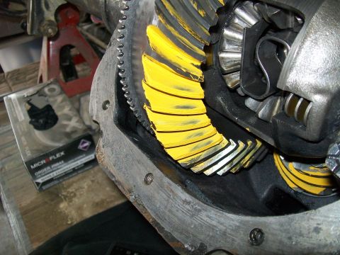 1991 Ford Bronco - A close-up view of the differential gears of a vehicle, with yellow paint applied to the teeth of the ring gear. A box of Micro Flex nitril…