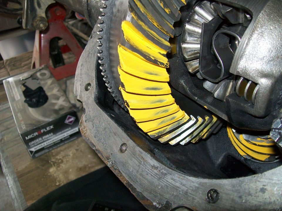 Differential gears with yellow paint markings and a box of nitrile gloves.
