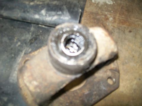 1991 Ford Bronco - This close-up shot shows a worn metal component, likely a vehicle part, with visible signs of rust and use.