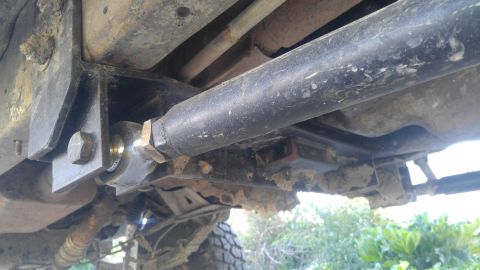 1991 Ford Bronco - Underside view of a modified vehicle suspension system with visible aftermarket parts.