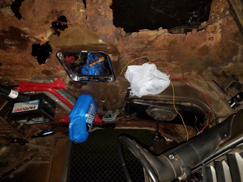 1979 Ford Bronco - The interior of a 1979 Ford Bronco shows significant rust damage and exposed wiring.