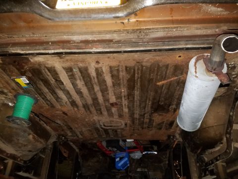 1979 Ford Bronco - Vehicle's undercarriage with visible rust and an exhaust system.