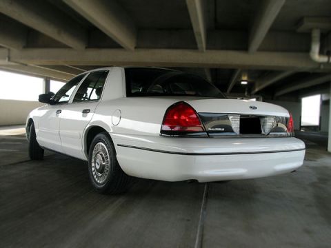 2000 Ford Crown Victoria - Rear view of a white 2000 Ford Crown Victoria parked in a garage.