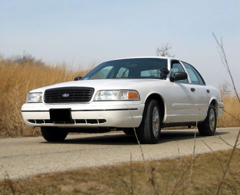 2000 Ford Crown Victoria - A white 2000 Ford Crown Victoria is shown from the front-right angle on a paved road.