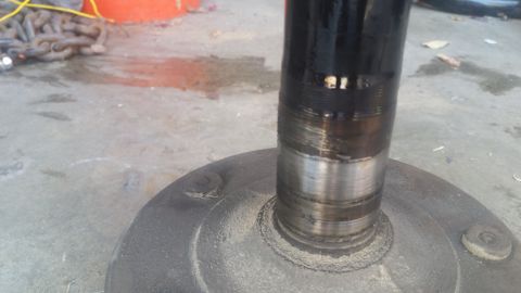 1992 Ford Bronco - Close-up of an axle shaft and hub assembly, showing wear on the shaft.