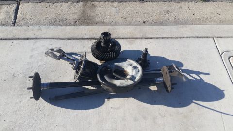 1992 Ford Bronco - Various differential and axle components are displayed on a paved surface.