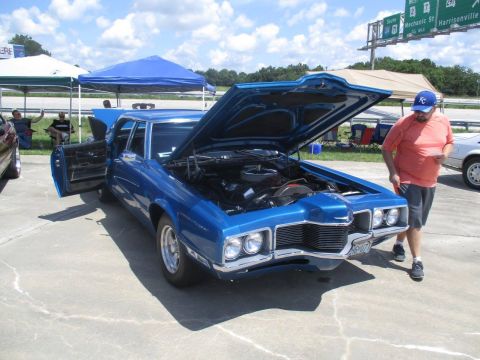 2004 Ford Crown Victoria - A blue sedan is displayed with its hood open, showing the engine compartment.