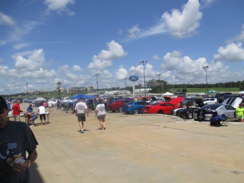 2004 Ford Crown Victoria - A car meet with numerous Ford Mustangs displayed in an outdoor lot.