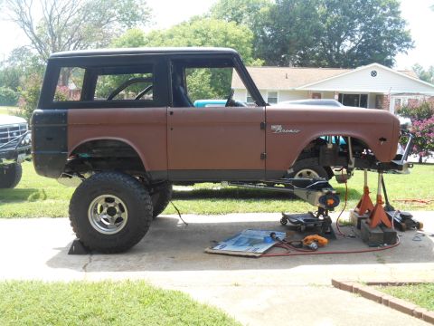 1972 Ford Bronco - This 1972 Ford Bronco is shown in profile while being worked on, lifted on jack stands with its wheels removed.