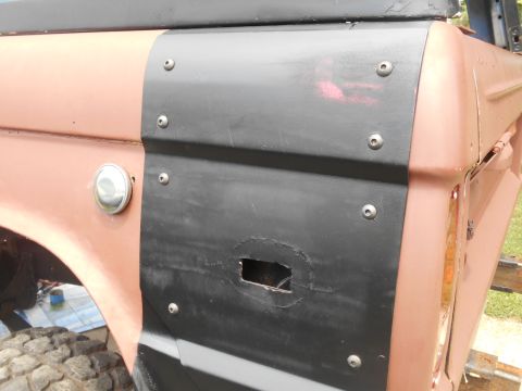 1972 Ford Bronco - 1972 Ford Bronco rear quarter panel shows added black trim over a cut-out section.
