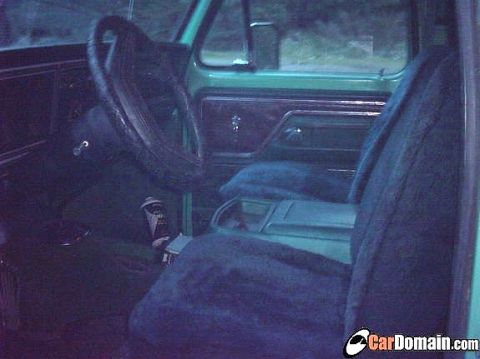 1978 Ford Bronco - The interior of a vintage vehicle is captured, highlighting the driver's side and passenger seating area.