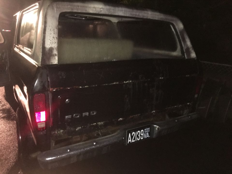 Rear driver's side of a black 1979 Ford Bronco with a chrome bumper and license plate.