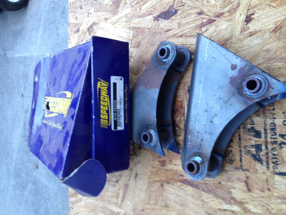 Blue Speedway box and two rusty metal brackets on wood